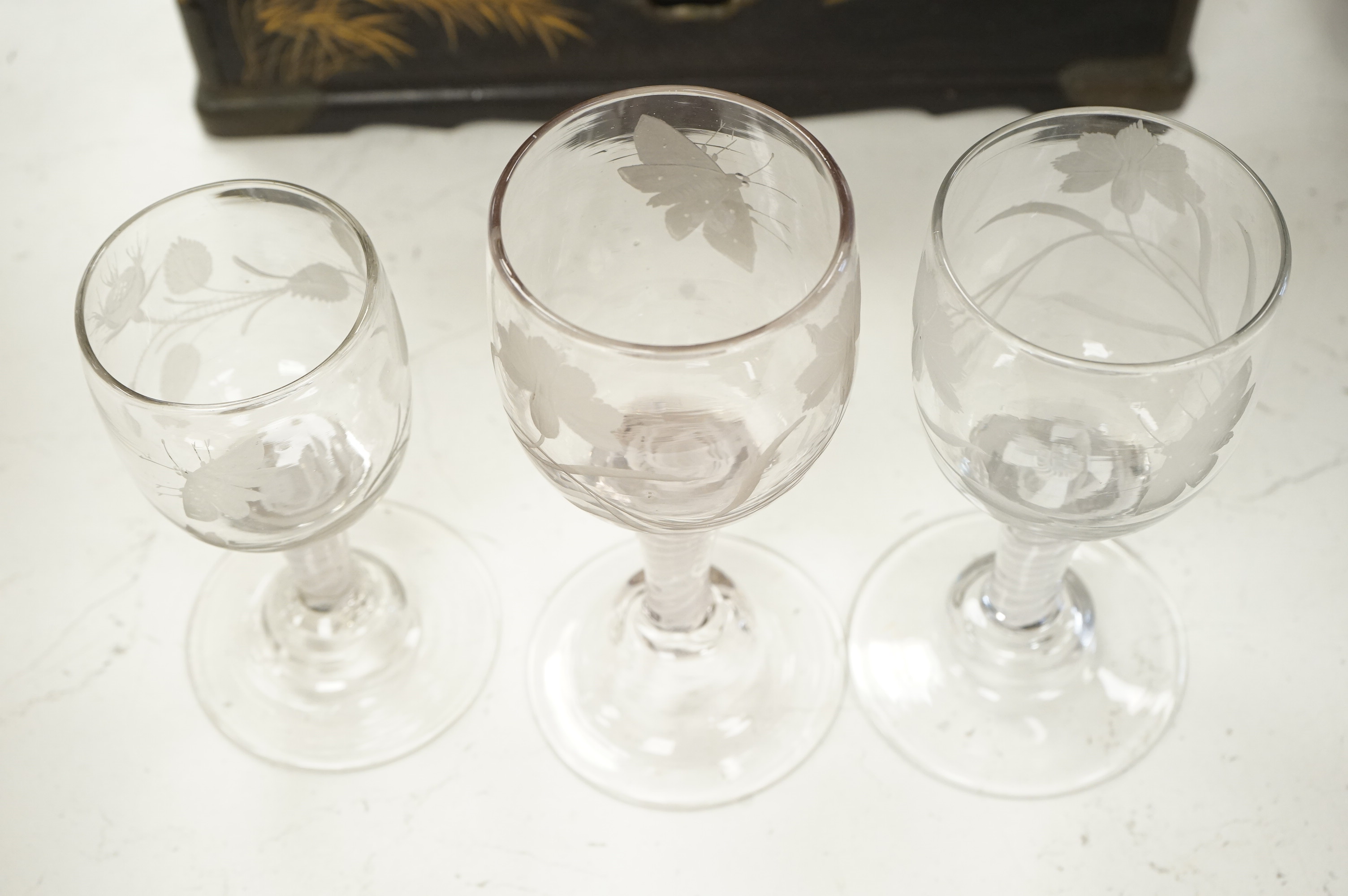 Three late 18th century Dutch DSOT stem goblets, each on a domed foot, engraved with a moth and flowers, 19.5cm and 18cm high